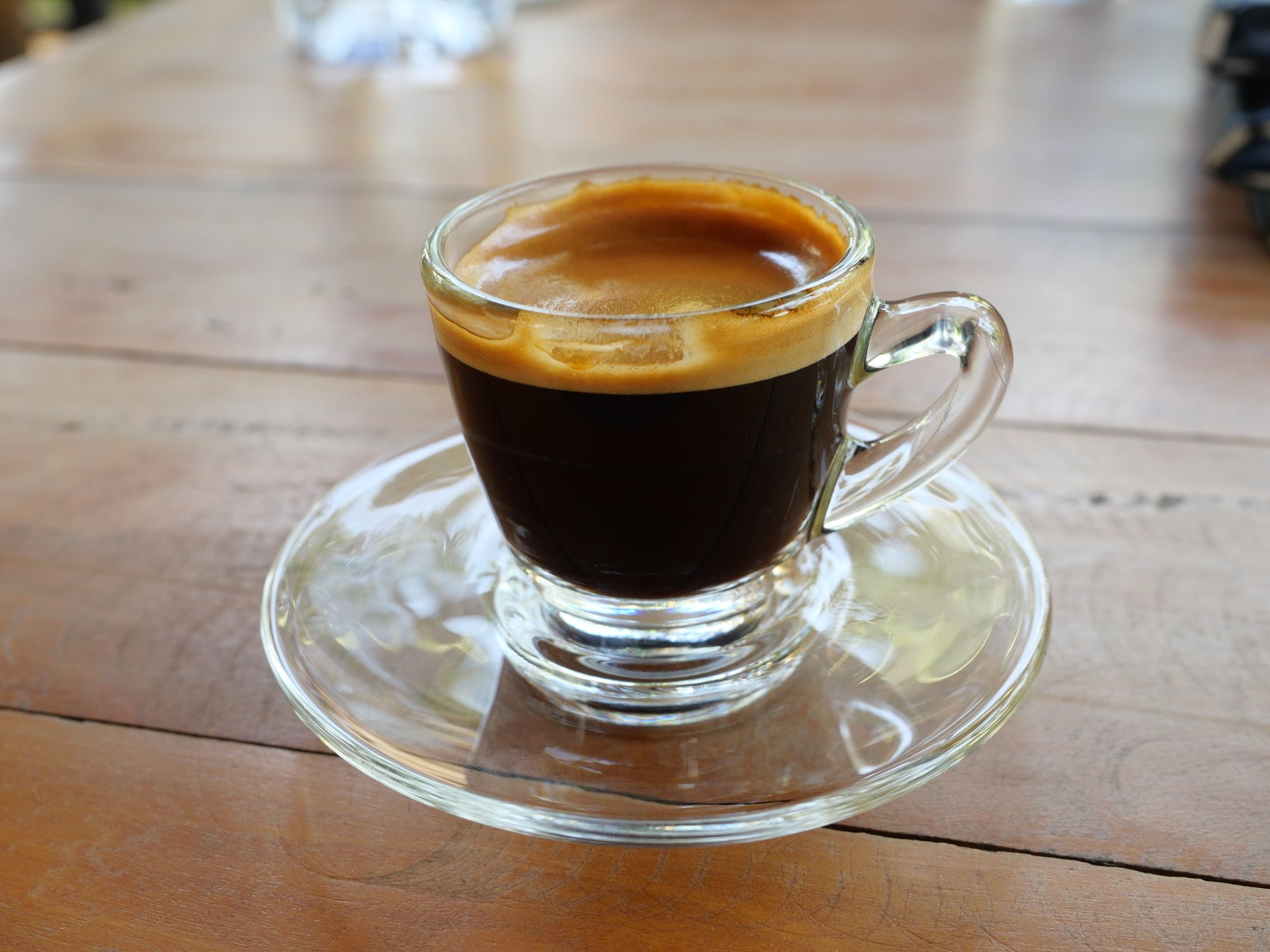Hot Espresso Coffee in a transparent glass cup