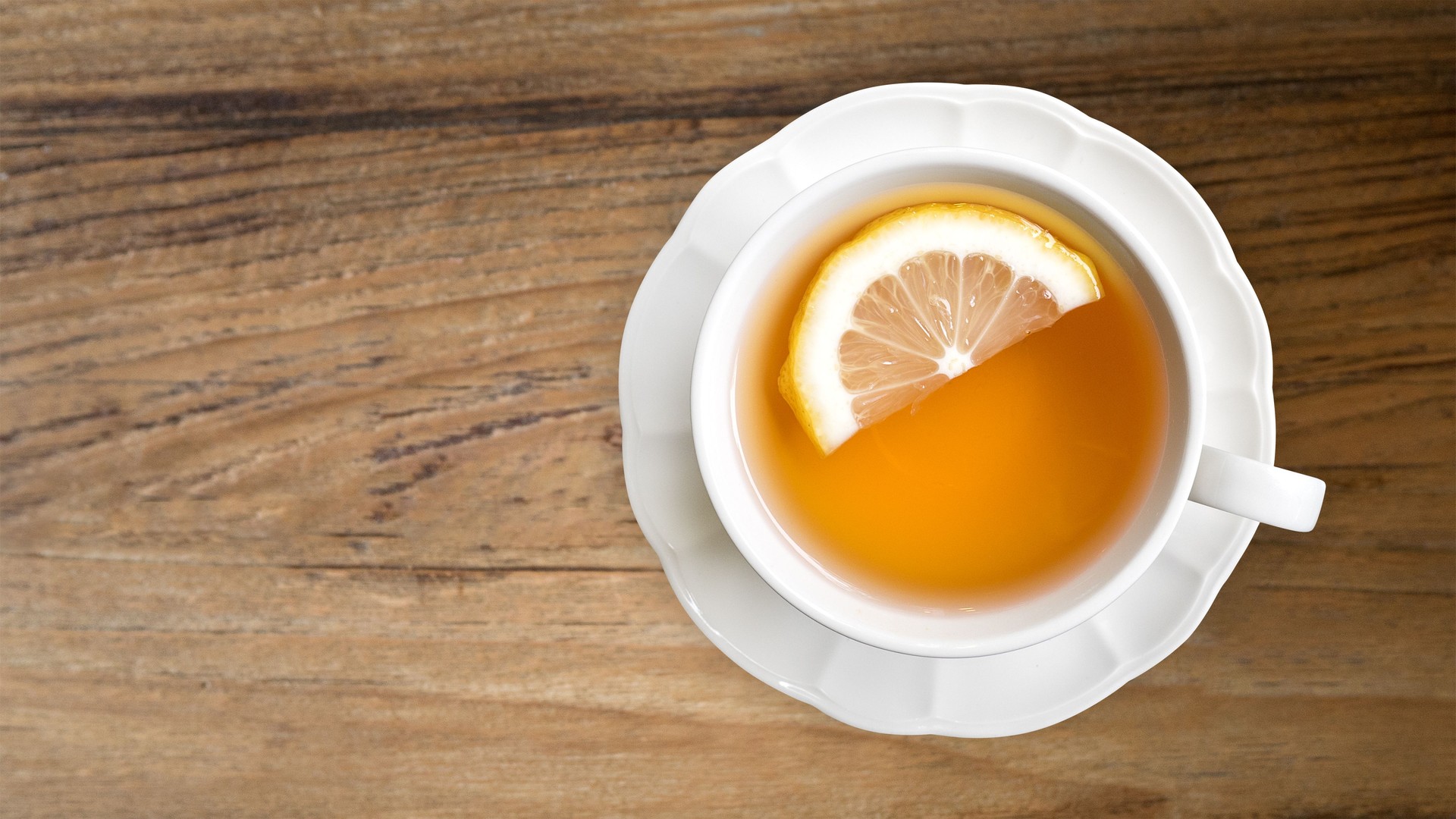 Hot earl grey tea with lemon slice top view on wood table background